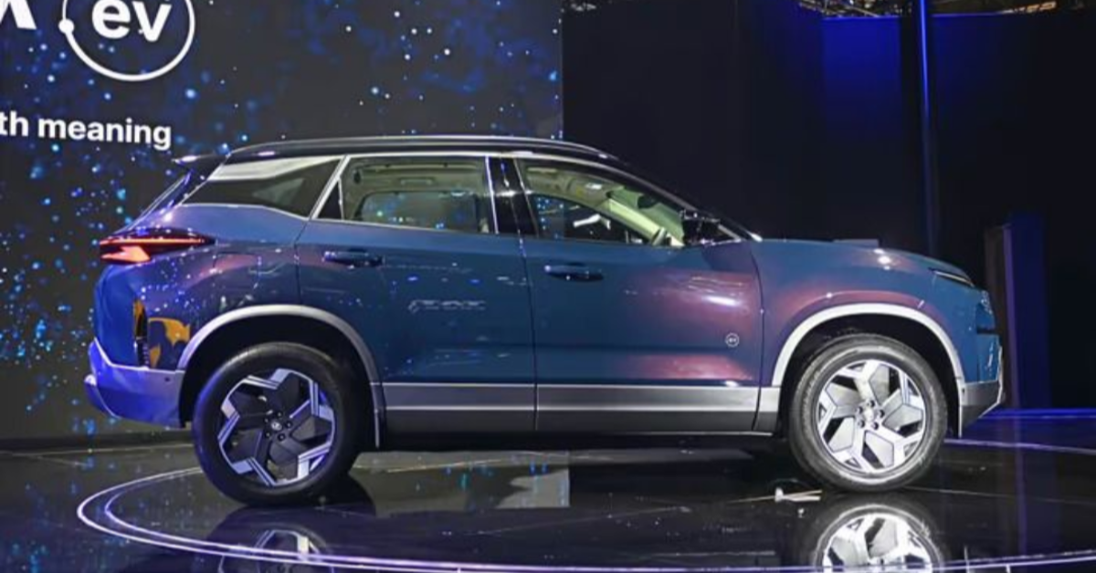 Tata Harrier EV 2025 electric SUV parked near a charging station in India with modern design and futuristic lighting